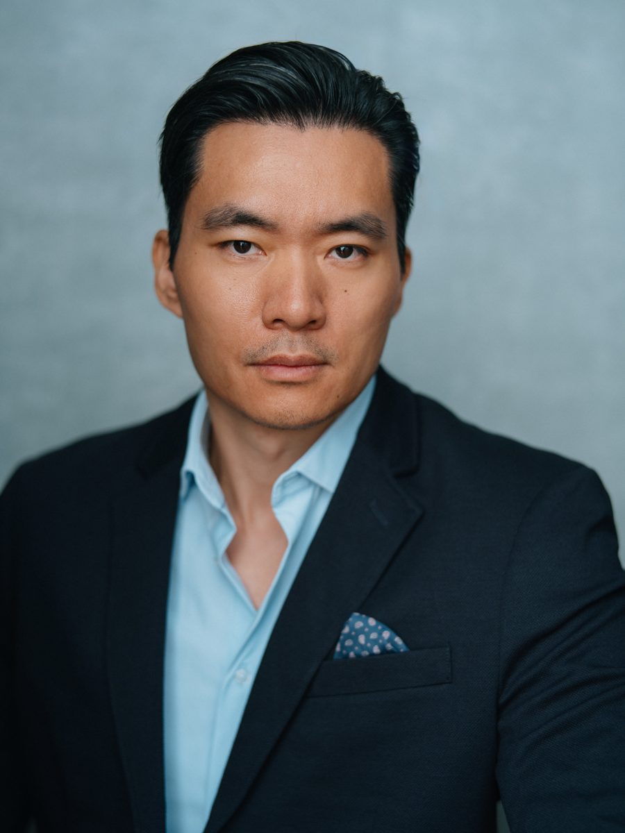 Headshot of Young-H. Lee in a dark blazer with a pocket square