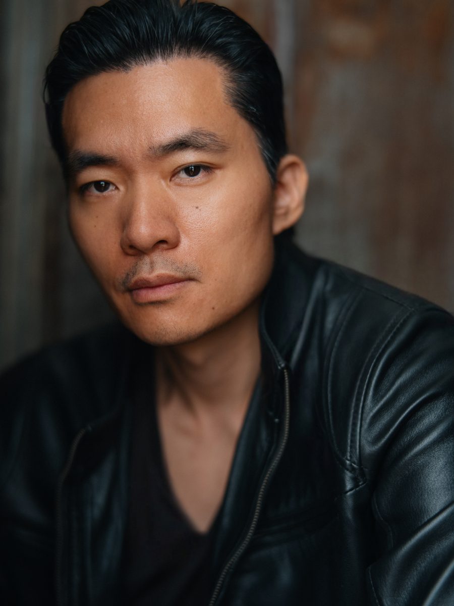 Headshot of Young-H. Lee in a black leather jacket, head tilted