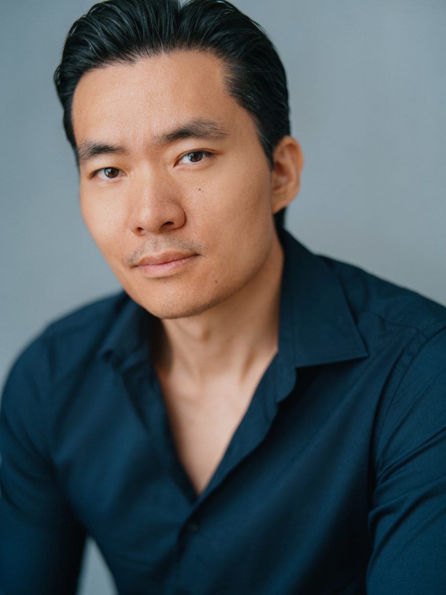 Headshot of Young-H. Lee in a navy shirt, serious
