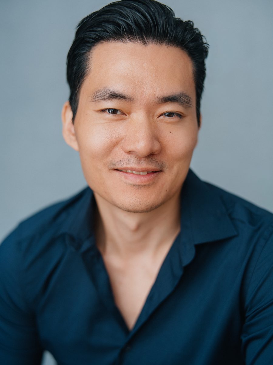Headshot of Young-H. Lee in a navy shirt, smiling